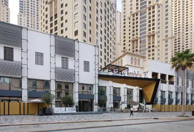 a building in a city with tall buildings at Rove JBR in Dubai