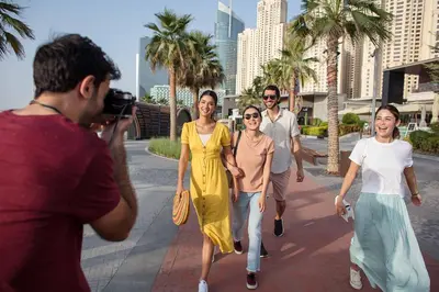 a group of people walking down the street at Rove JBR in Dubai