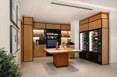 a kitchen with a table and a refrigerator at Rove JBR in Dubai