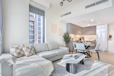 a living room with a couch and a table at Elegant 1BR Retreat in Riviera 36 Near Downtown in Dubai