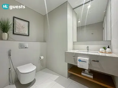 a bathroom with a toilet and a sink and a mirror at HiGuests - Ocean Views and Comfort in La Vie, JBR in Dubai