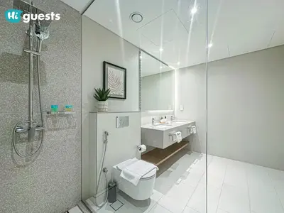 a bathroom with a shower and a toilet and a sink at HiGuests - Ocean Views and Comfort in La Vie, JBR in Dubai