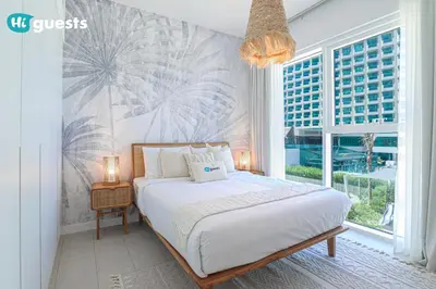 a bedroom with a bed and a large window at HiGuests - Ocean Views and Comfort in La Vie, JBR in Dubai