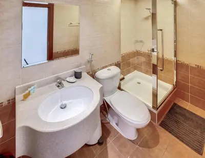 a bathroom with a sink and a toilet and a tub at Stylish 2bd with great view in Marina View Tower in Dubai