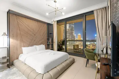 a bedroom with a large bed and a large window at Luxe 3BR Retreat, Balcony Burj & Fountain Views, Prime Downtown Stay in Dubai