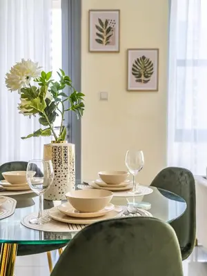 a dining room with a table with chairs and a vase at Downtown Luxury Living -1BR-Standpoint Tower A in Dubai