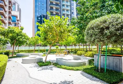 a park with benches and trees in a city at Zapbed House - Modern Studio in Azizi Riviera 27 Meydan One in Dubai
