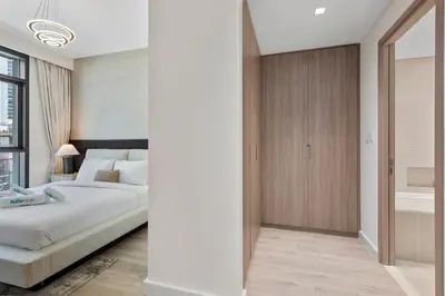 a bedroom with a large bed and a bathroom at Luxury 2 bedroom in Dubai Creek Harbour- Suiteable in Dubai
