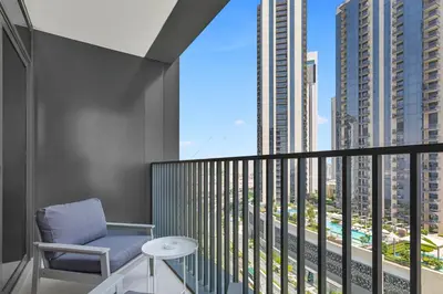 a balcony with a chair and a view of a city at Luxury 2 bedroom in Dubai Creek Harbour- Suiteable in Dubai