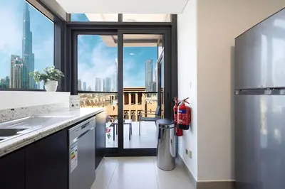a kitchen with a view of a city skyline at Iconic Burj Khalifa Views from Luxury 1BR Home in Dubai