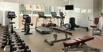 a gym with many exercise equipment in a room at Charming 1BR in Damac Heights, Dubai Marina by Deluxe Holiday Homes in Dubai