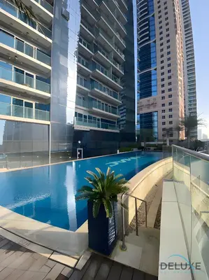 a swimming pool in a building with tall buildings at Charming 1BR in Damac Heights, Dubai Marina by Deluxe Holiday Homes in Dubai