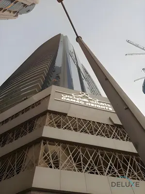 a view of the belle tower from the street at Charming 1BR in Damac Heights, Dubai Marina by Deluxe Holiday Homes in Dubai