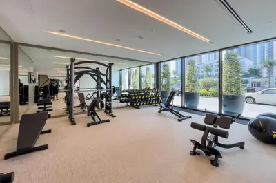 a gym with treadmills and exercise equipment in a building at GuestReady - Upscale living at Palace Residence in Dubai