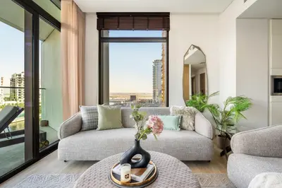 a living room with a couch and a table at GuestReady - Upscale living at Palace Residence in Dubai