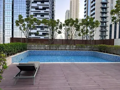 a swimming pool in a city with buildings at Modern Comfort1BR RP Heights 5-min Dubai Mall in Dubai
