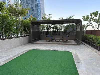 a patio with a green floor in a building at Modern Comfort1BR RP Heights 5-min Dubai Mall in Dubai