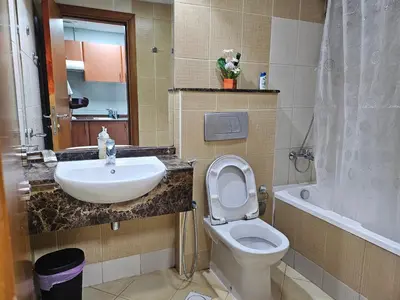 a bathroom with a sink and a toilet and a tub at Stunning Apartment, Partial Sea View, Canal Marina View, 5 min walk To JBR Beach and METRO in Dubai