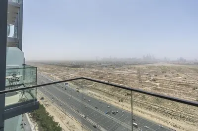 a view of a highway from the balcony of a building at Cosy Studio Apartment in Bloom Towers, Jumeirah Village Circle in Dubai
