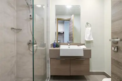a bathroom with a sink and a shower at Cosy Studio Apartment in Bloom Towers, Jumeirah Village Circle in Dubai
