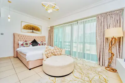 a bedroom with a bed and a chair and a window at Luxury Studio - Downtown Dubai 6 Minute Walk to Burj Khalifa & Dubai Mall in Dubai