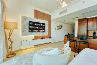 a living room with a white couch and a table at Luxury Studio - Downtown Dubai 6 Minute Walk to Burj Khalifa & Dubai Mall in Dubai