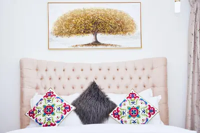 a picture of a tree above a bed with pillows at Luxury Studio - Downtown Dubai 6 Minute Walk to Burj Khalifa & Dubai Mall in Dubai