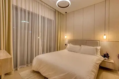 a bedroom with a white bed and a window at Apartment 1015 Waves in Dubai