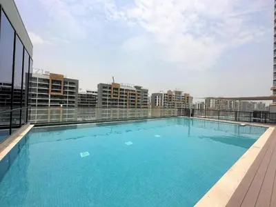 a large swimming pool on the roof of a building at Apartment 1015 Waves in Dubai