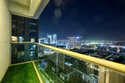 a view of a city at night from a building at Apartment 1015 Waves in Dubai
