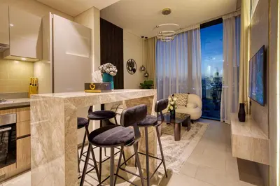 a kitchen with a bar and a living room at Apartment 1015 Waves in Dubai