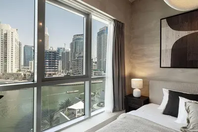 a bedroom with a large window with a view of the city at Marina Elegance, Your Dream Dubai Marina Stay in Dubai