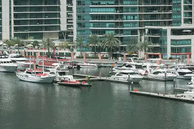 a group of boats docked in a harbor with buildings at Marina Elegance, Your Dream Dubai Marina Stay in Dubai