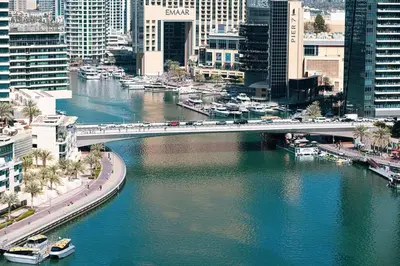 a bridge over a river in a city with buildings at Marina Elegance, Your Dream Dubai Marina Stay in Dubai