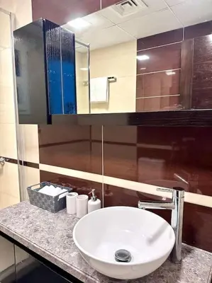 a bathroom with a white sink and a mirror at Luxury sea-view apartment in Dubai