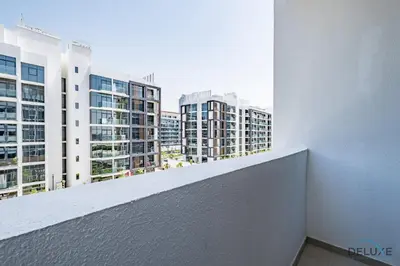 a balcony with a view of tall buildings at Charming Studio at Azizi Riviera 32, Al Merkadh by Deluxe Holiday Homes in Dubai