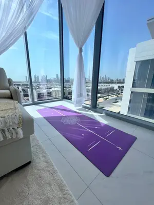 a living room with a purple rug in front of a window at Luxury Apt Burj Khalifa, Sunset and Lagoon view in Dubai