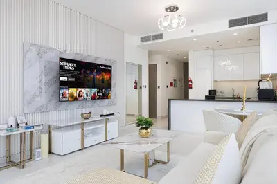 a living room with a couch and a table at Luxury Apt Burj Khalifa, Sunset and Lagoon view in Dubai
