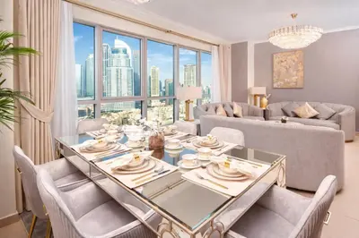 a dining room with a table and chairs and a large window at Elite Royal Apartment - Sky Series - Breathtaking View - Full Burj Khalifa & Fountain in Dubai