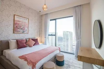 a bedroom with a bed and a large window at Offer! 1BR, Skyline View, Dubai Hills Estate, Park Ridge in Dubai