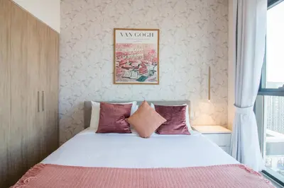 a bedroom with a large bed with pink pillows at Offer! 1BR, Skyline View, Dubai Hills Estate, Park Ridge in Dubai