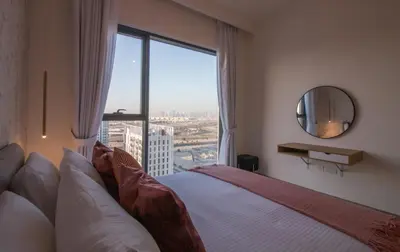 a bedroom with a bed and a large window at Offer! 1BR, Skyline View, Dubai Hills Estate, Park Ridge in Dubai