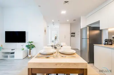 a kitchen with a table with plates on it at Delightful 2BR Apartment in Town Square Safi 1A, Dubailand by Deluxe Holiday Homes in Dubai
