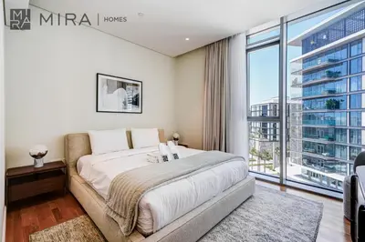 a bedroom with a large bed and a large window at Mira Holiday Homes - Luxury 2 bedroom in Bluewaters with stunning view in Dubai