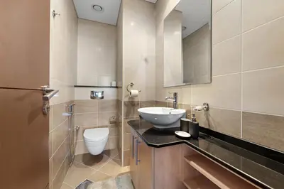 a bathroom with a sink and a toilet at StoneTree - High Floor - Prime location in Dubai