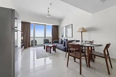 a living room with a table and a couch at StoneTree - High Floor - Prime location in Dubai