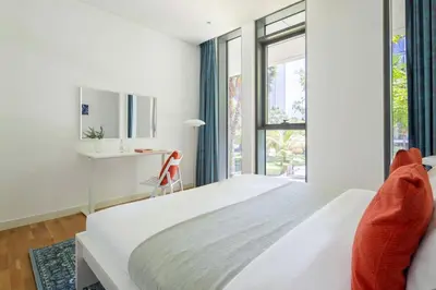 a white bedroom with a bed and a window at Frank Porter - Bluewaters Residences Building 5 in Dubai
