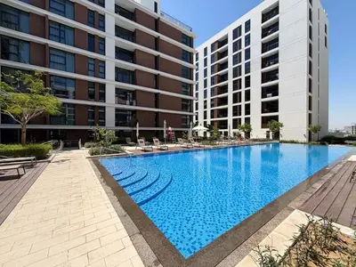 a large swimming pool in front of a building at Frank Porter - Park Point Building C in Dubai