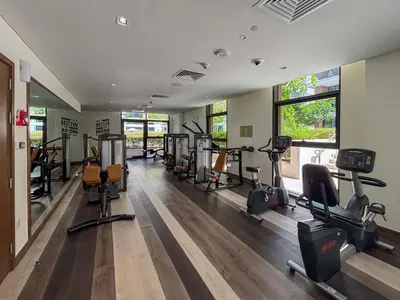 a gym with several treadmills and elliptical machines at Frank Porter - Park Point Building C in Dubai
