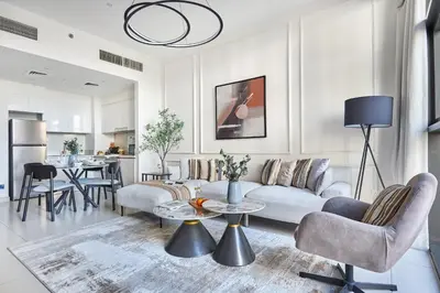 a living room with a couch and a table at Frank Porter - Park Point Building C in Dubai